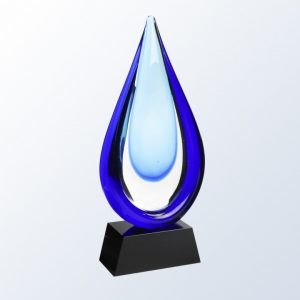 Glass drop of water with two shades of blue mounted on a black glass base.