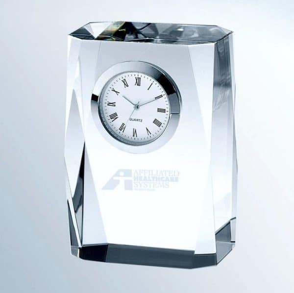 A short crystal column with a silver bezel clock at the top and a blank engraving area at the bottom for personalization.