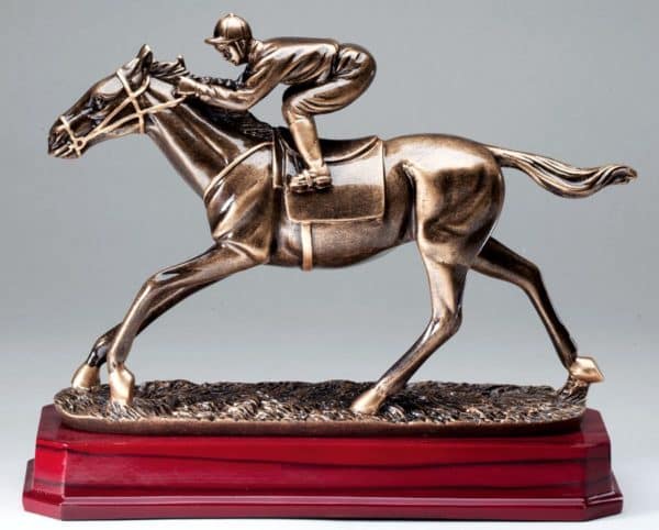 A bronze resin statue of a race horse & jockey in the middle of a race. It's mounted on a rosewood base.