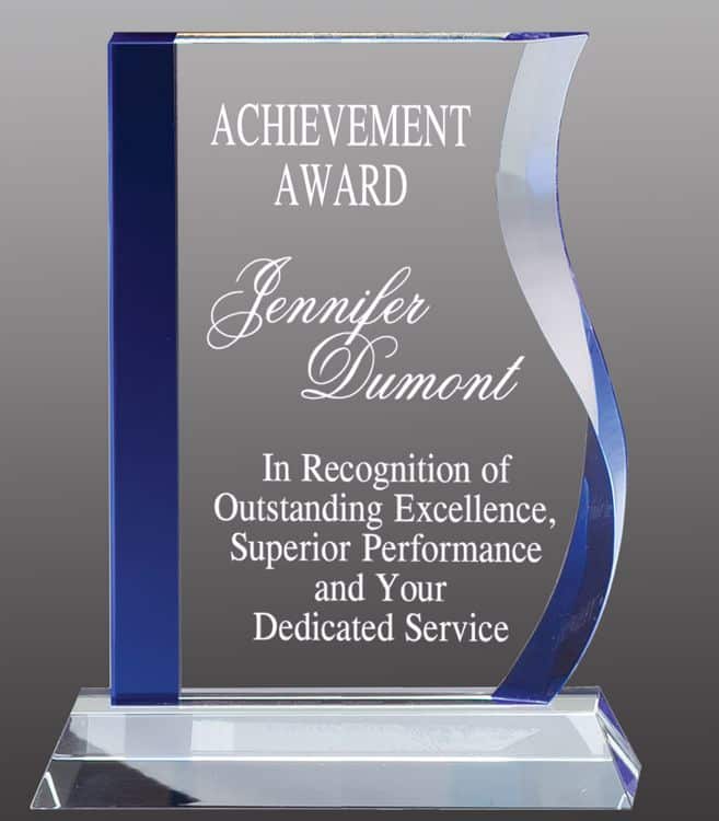 A crystal awards with a blue accent on the left side and a wave design on the right side. The middle is for laser engraving personalization. The engraving is for an achievement award. It's all mounted on a clear crystal base.