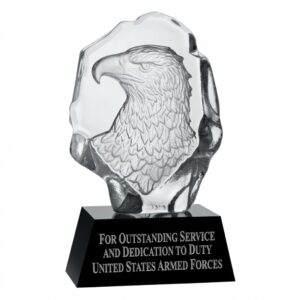 A high-resolution photograph of the Crystal Eagle Bust award (model G2209B) on a transparent background. The award features a finely detailed 3D carved eagle head and bust inside a clear optical crystal block, mounted on a sleek black crystal base. The base is engraved in elegant silver lettering with the text: 'FOR OUTSTANDING SERVICE AND DEDICATION TO DUTY / UNITED STATES ARMED FORCES'. This 8-inch tall patriotic military recognition trophy symbolizes strength, freedom, and excellence.