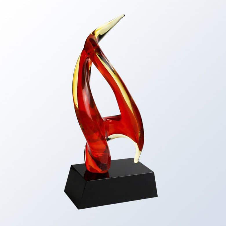 A uniquely shaped piece of glass with red & yellow colors to signify an inferno. It's mounted on a black glass base that includes a place for laser engraving personalization.