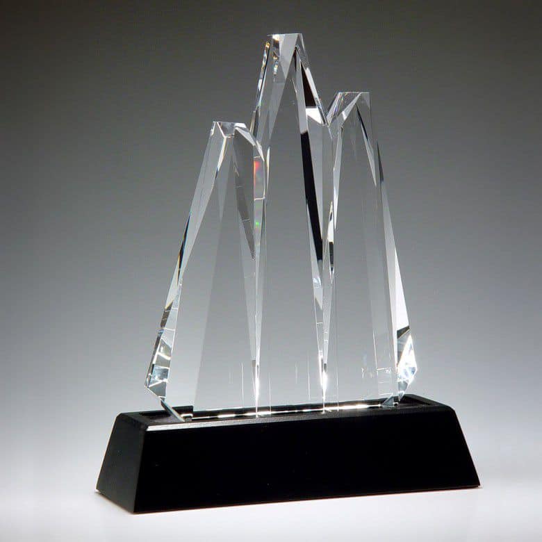A crystal trophy with 3 peaks in the shape of mountain tops, thus it's name "Reach for the Summit." They're mounted on a black crystal base that includes a black & silver engraving plate for personalization.