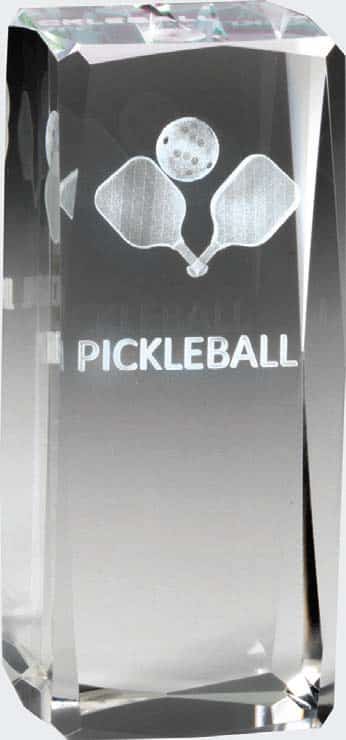 A crystal pillar with two 3-D Pickleball rackets, ball & the word pickleball laser engraved in the top half of the crystal trophy. Below that is a blank space for laser engraving personalization of tournament or league name and also the names of the winners.