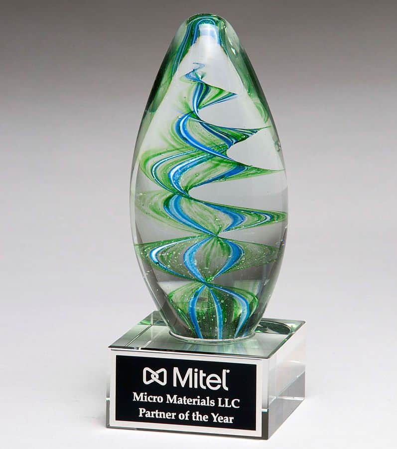 A glass egg with a blue & green helix in the middle. It's mounted on a clear glass base with a black & silver engraving plate that is personalized for the recipient.