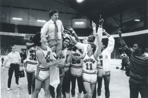 Rick Pitino being carried off the court after he lead Boston University to their first ever NCAA Men's Basketball Tournament birth.