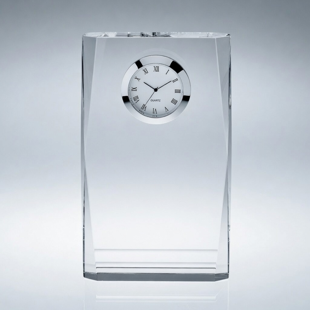 A modern rectangular crystal desk clock with a round white clock face and silver trim, set into a thick faceted crystal plaque. Sleek, elegant design ideal for personalized engraving, corporate gifts, and executive awards.