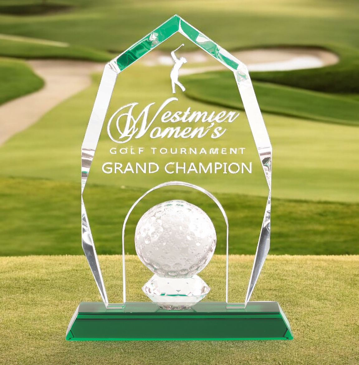 Our Crystal Apex Golf Award features a clear piece of crystal with an apex at the top & a solid crystal golf ball at the bottom. The middle area is for laser engraving personalization. It's mounted on a green crystal base. This specific trophy was made for Westmier Women's Golf Tournament Grand Champion.
