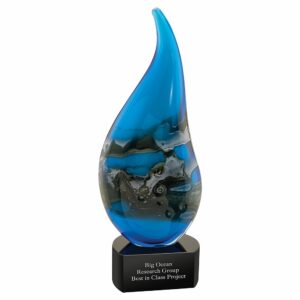 Our Ocean Flame Art Glass Award features a flame shaped piece of glass that is predominately blue with black, white & gray accents. It's mounted on a black glass base with an engraving plate. This one is personalized for Big Ocean Research Group for winning the Best in Class Project. AGS68 art glass award is 4.5" x 11.5" in size and weighs 5.2 lbs.