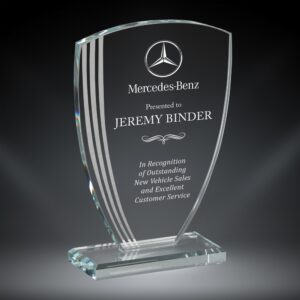 Our Contour Arch Glass Award features a glass piece that is smaller at the bottom, gets larger towards the top & has an arched top. The left side has 3 contour lines for design, while the right side is for laser engraving personalization. It's mounted on a matching base to help it stand. This specific award is personalized for Jeremy Binder who works at Mercedes-Benz. This arch glass award comes in 3 sizes to choose from: 75507 is 7.75", 75508 is 8.5" and 75509 is 9.25" tall. All sizes come in a deluxe gift box.