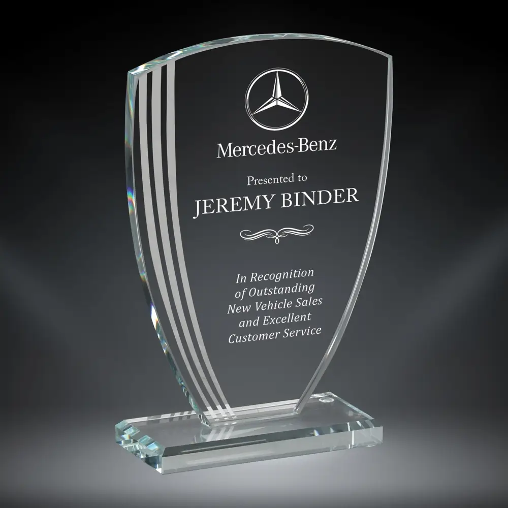 Our Contour Arch Glass Award features a glass piece that is smaller at the bottom, gets larger towards the top & has an arched top. The left side has 3 contour lines for design, while the right side is for laser engraving personalization. It's mounted on a matching base to help it stand. This specific award is personalized for Jeremy Binder who works at Mercedes-Benz. This arch glass award comes in 3 sizes to choose from: 75507 is 7.75", 75508 is 8.5" and 75509 is 9.25" tall. All sizes come in a deluxe gift box.