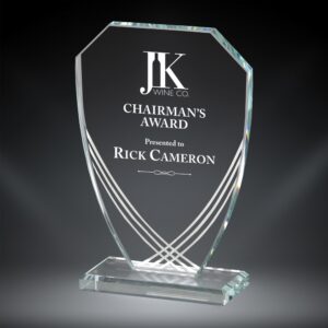 Our Contour Imperial Glass Award features a shield shaped piece of glass for laser engraving personalization. It has white contour lines towards the middle & bottom for decoration. It's mounted on a matching base for added stability. This glass trophy comes in 3 sizes to choose from: 75407 is 7" tall, 75408 is 7.75" & 75409 is 8.5" in height. All sizes include free engraving & come in a deluxe gift box.