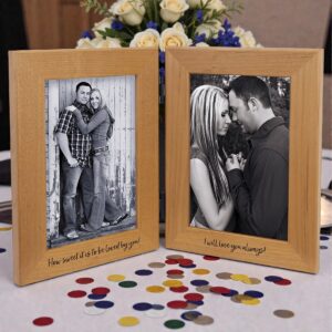 Our Dual Picture Frame displayed here at a wedding reception. It features two wood frames held together by two hinges. The frames hold 4x6 photos and are showing a couple in love. It's sitting on a white table with white roses in the background and decorative, colorful dots in front of the frame on the table. This PTF646D frame is 11.5" x 7.5" in size, weighs 1.4 lbs. & includes free engraving.