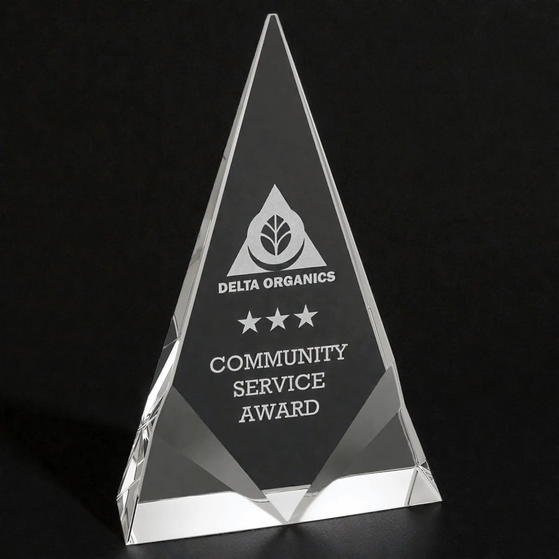 Our Crystal Trophy Award shown here on a black table & a black background as well. The award features a middle area for laser engraving personalization. The bottom corners are accented with decorative front bevels. This is the CRY261M Crystal Triangle that is 5" x 8" in size & weighs 3.0 lbs.