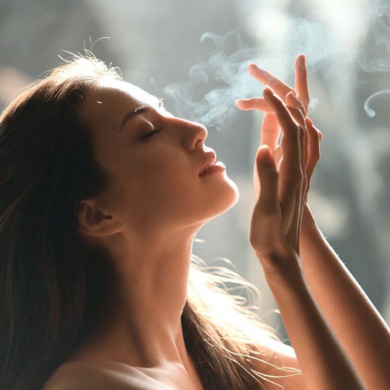 A woman who is enjoying a pleasant scent that's floating through the air. Presumably she's enjoying the smell of one of Hit Trophy's Aroma Awards that they released on April 1st, 2026.