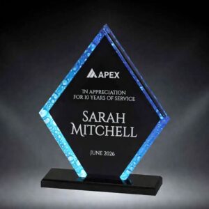 Our Aqua Pentagon Acrylic Award features a pentagon shaped piece of acrylic with a black middle that is for laser engraving personalization with a blue water droplet them design for a border. It's mounted on a black acrylic base.