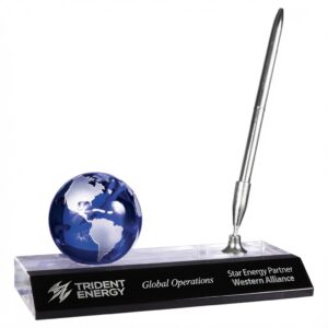 Our Crystal Globe Pen Set features a clear crystal base with a blue crystal globe to the left and silver pen to the right. On the front of the base is a black & silver engraving plate that laser engraves silver. This CRY7211 pen set is 3" x 7" in size and weighs 2.9 lbs.