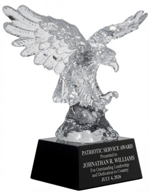 Striking Crystal Eagle Award (CRY810) featuring a large, highly detailed optical crystal American eagle in a powerful attacking pose with wings dramatically spread and talons extended, mounted on a sleek black crystal base. The base is engraved with: 'PATRIOTIC SERVICE AWARD Presented to JONATHAN R. WILLIAMS For Outstanding Leadership and Dedication to Country JULY 4, 2026'. This premium 10.25″ x 10.5″ (14.4 lbs) patriotic military recognition trophy symbolizes strength, courage, and excellence.