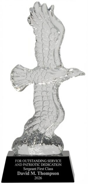 Wings of Majesty Crystal Eagle Statue (CRY805) featuring a large, highly detailed optical crystal eagle in a soaring flight pose with fully spread wings and intricate feather detailing, mounted on a sleek black crystal base. The base is engraved with: 'FOR OUTSTANDING SERVICE AND PATRIOTIC DEDICATION / Sergeant First Class David M. Thompson / 2026'. This premium 4.75″ x 11.25″ (5.1 lbs) patriotic award symbolizes freedom, strength, and honor.